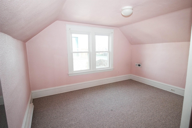 bonus room with carpet floors, lofted ceiling, and baseboards