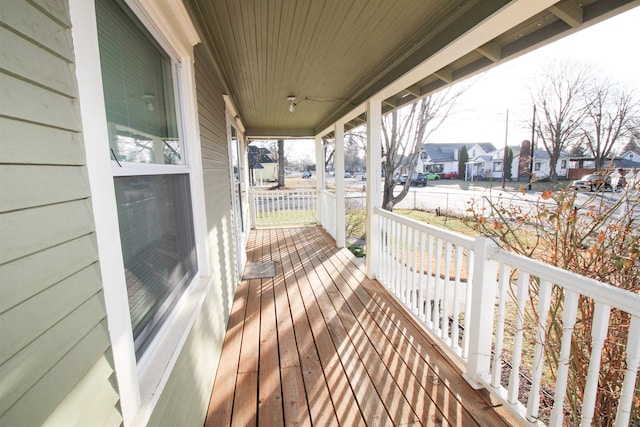 wooden deck with a residential view and a porch