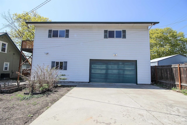 exterior space featuring central air condition unit, an attached garage, fence, and driveway