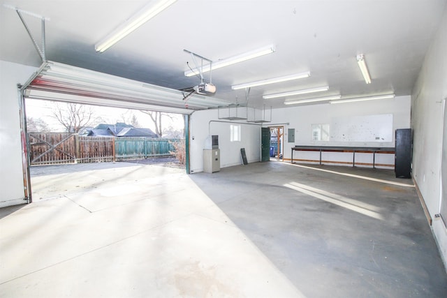 garage featuring electric panel and a garage door opener
