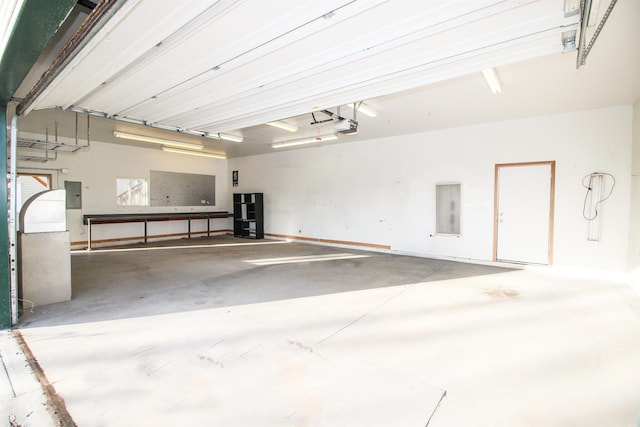 garage featuring a garage door opener and electric panel