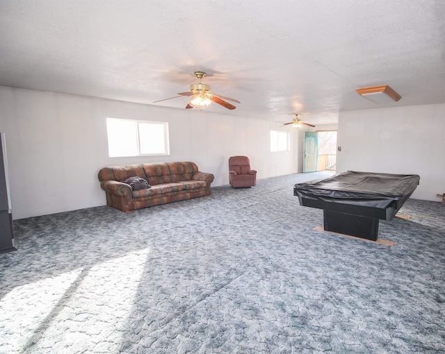 recreation room with carpet, a healthy amount of sunlight, and a ceiling fan
