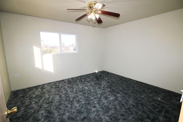 spare room featuring carpet and a ceiling fan