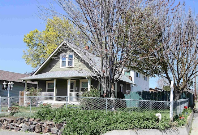 view of front of home with a porch and fence