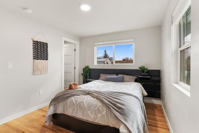 bedroom featuring baseboards and wood finished floors