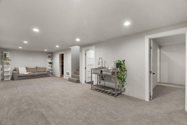 living room featuring carpet floors, recessed lighting, visible vents, and stairs