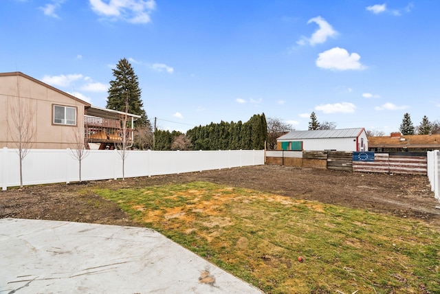 view of yard with fence and an outdoor structure