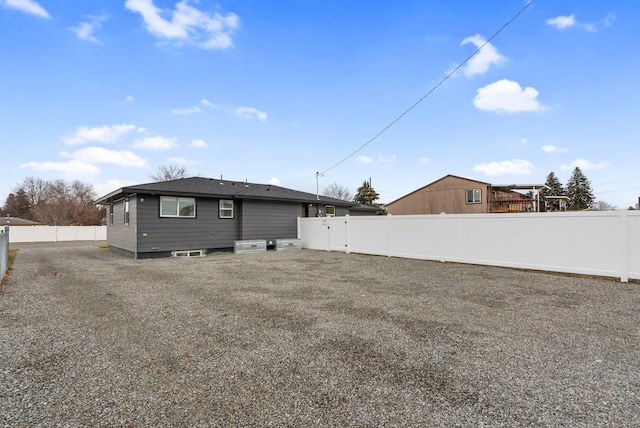 back of property featuring a fenced backyard