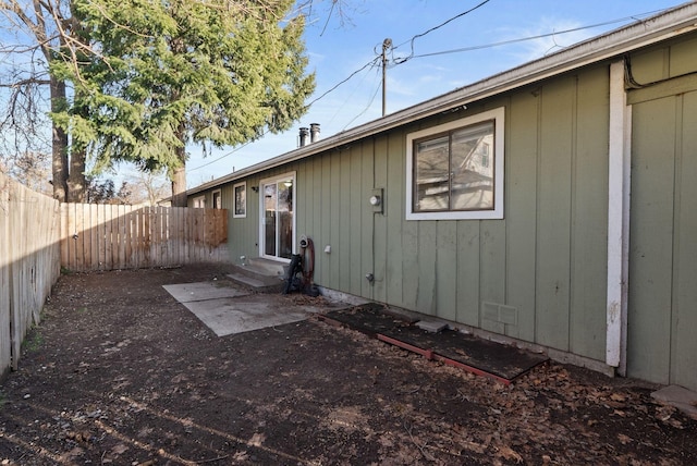 back of property featuring entry steps and a fenced backyard