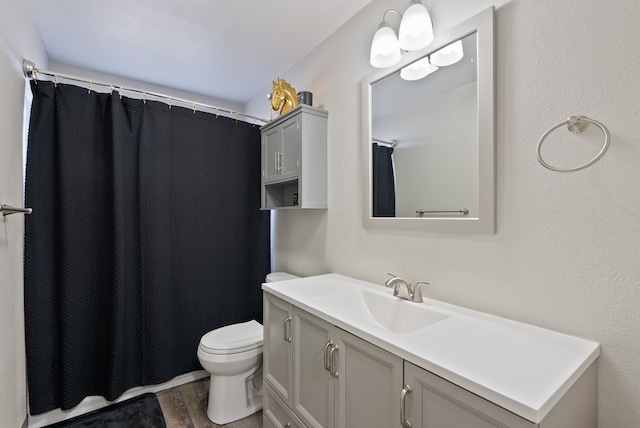 full bathroom with vanity, wood finished floors, toilet, and a shower with curtain