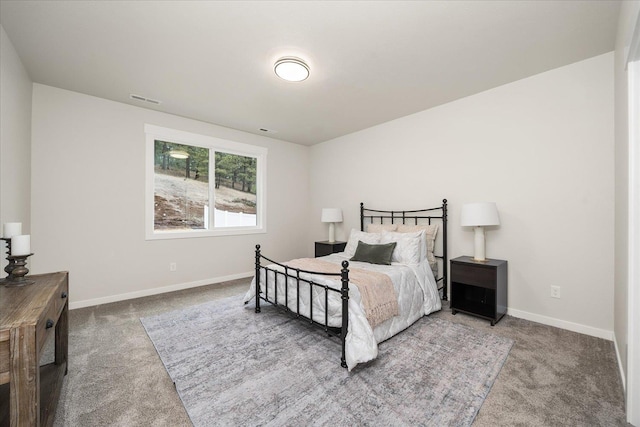 carpeted bedroom with baseboards and visible vents