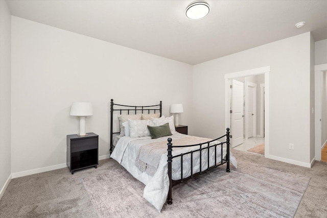 carpeted bedroom featuring baseboards