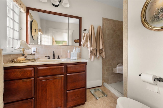 bathroom featuring toilet, walk in shower, decorative backsplash, and vanity