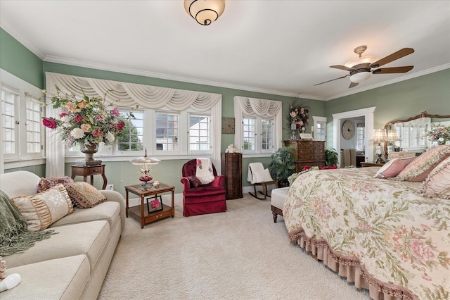 bedroom with carpet floors, a ceiling fan, and crown molding