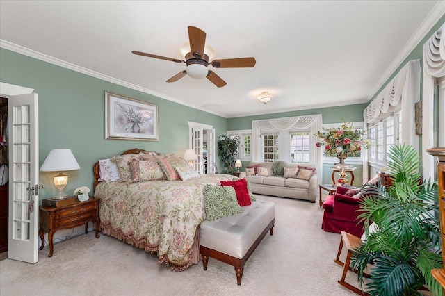 carpeted bedroom with ceiling fan, french doors, and crown molding