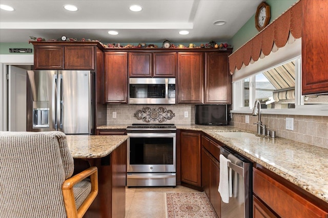 kitchen featuring appliances with stainless steel finishes, recessed lighting, a sink, and decorative backsplash