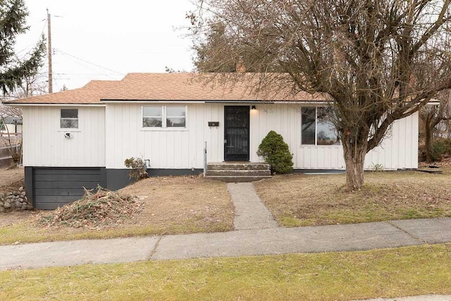 view of front facade with a garage and roof with shingles