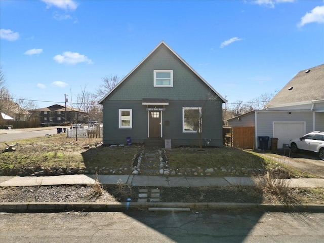 bungalow-style house with fence