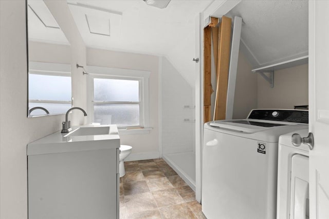 laundry room with washer / dryer, laundry area, a sink, and baseboards