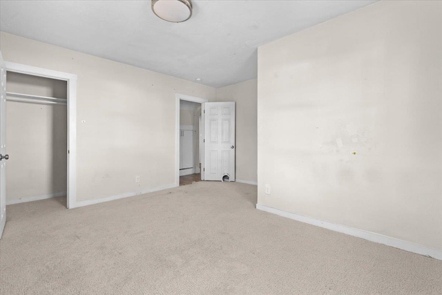 unfurnished bedroom featuring carpet flooring and baseboards