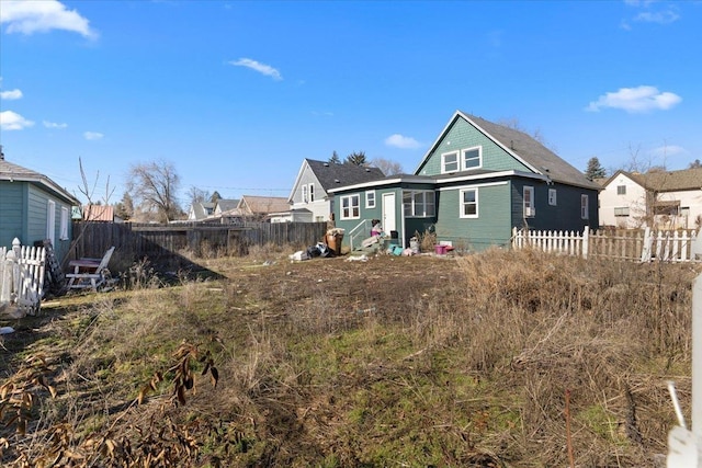 back of property featuring entry steps and fence private yard