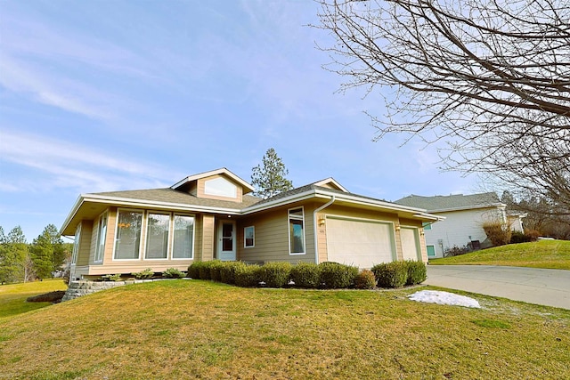 ranch-style house featuring an attached garage, driveway, and a front lawn