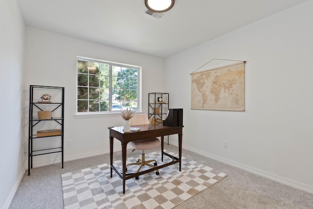 office area featuring visible vents, baseboards, and light colored carpet