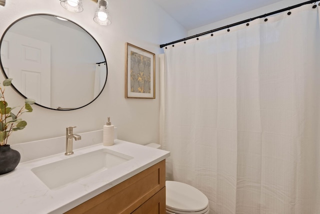 full bath featuring vanity and toilet