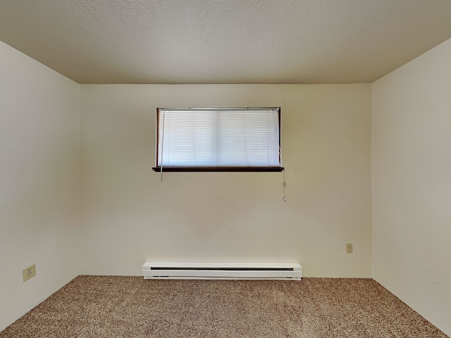 carpeted empty room featuring a textured ceiling and baseboard heating