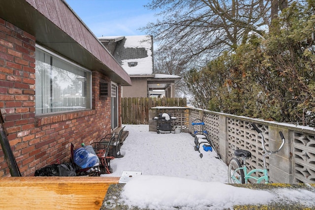 yard covered in snow with fence