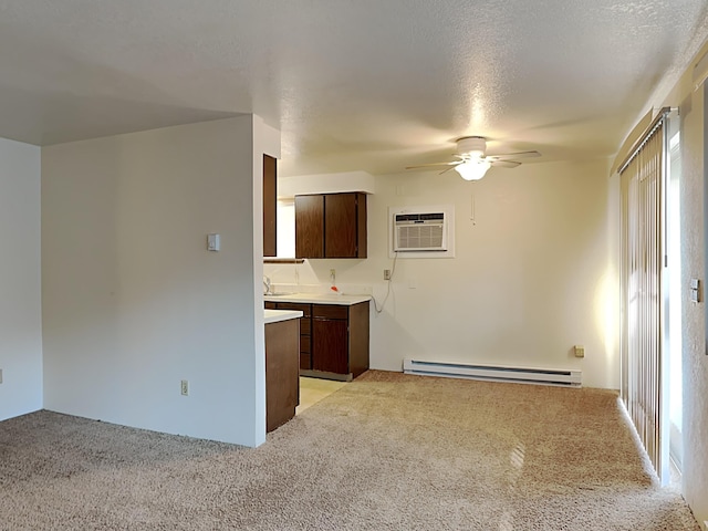 interior space with a baseboard heating unit, ceiling fan, a wall unit AC, and light colored carpet