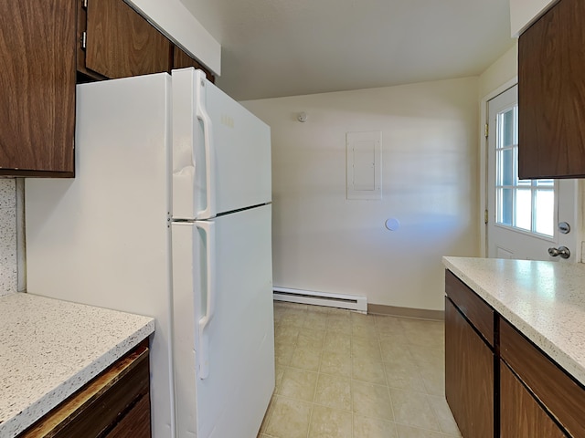 kitchen featuring a baseboard heating unit, light countertops, freestanding refrigerator, and dark brown cabinetry