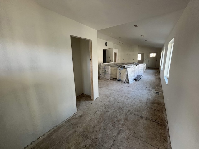 hallway with lofted ceiling