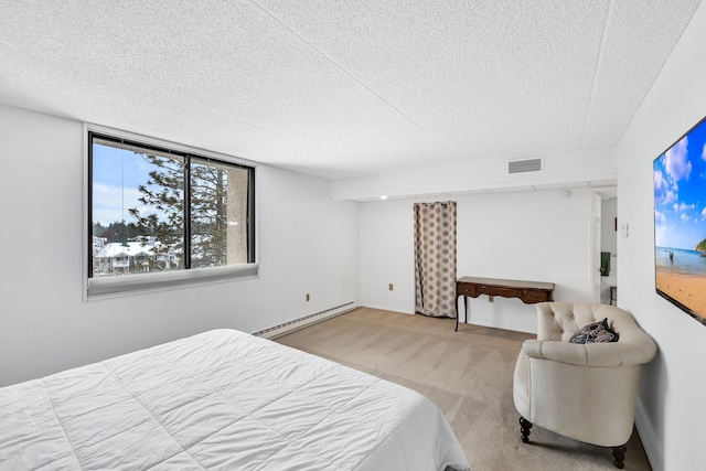 carpeted bedroom featuring a textured ceiling, baseboard heating, and visible vents