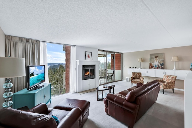 living area featuring light carpet, a lit fireplace, and floor to ceiling windows