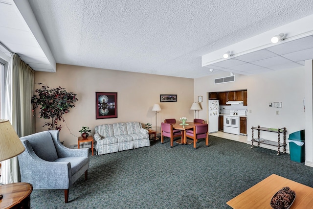 carpeted living area with visible vents, a textured ceiling, and baseboard heating