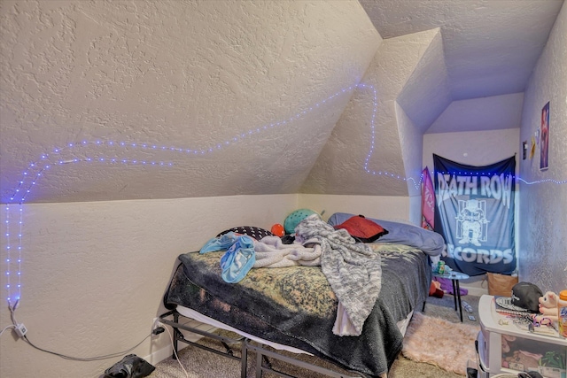 carpeted bedroom with vaulted ceiling, a textured wall, and a textured ceiling