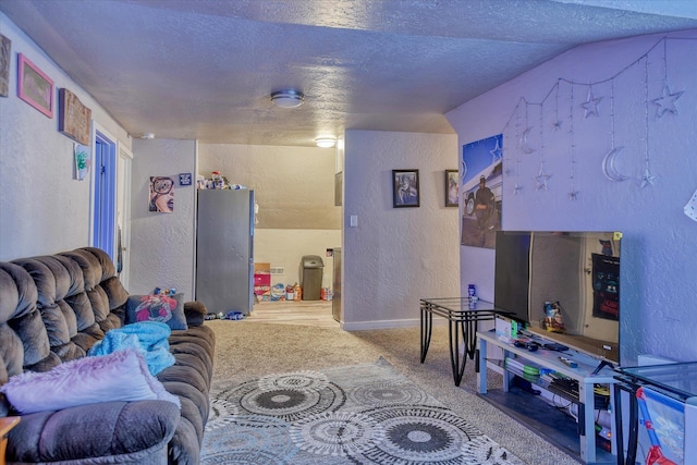 living area featuring carpet, vaulted ceiling, a textured ceiling, and a textured wall