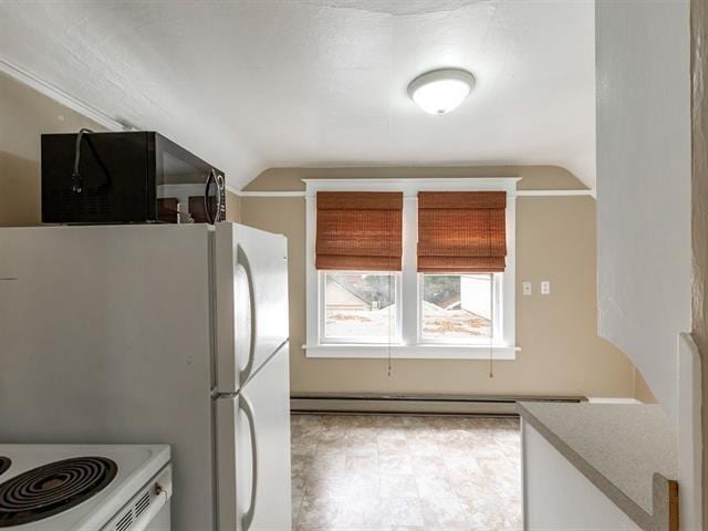 kitchen with light floors, lofted ceiling, black microwave, and baseboard heating