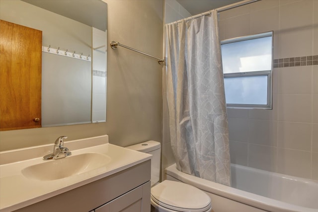 full bathroom with toilet, shower / bath combo with shower curtain, and vanity