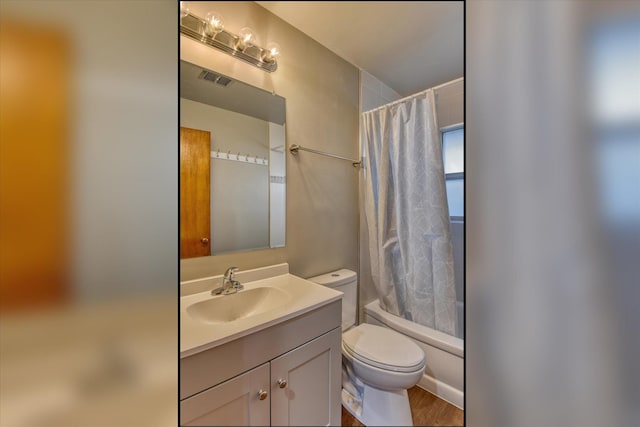 bathroom with shower / tub combo, visible vents, vanity, and toilet