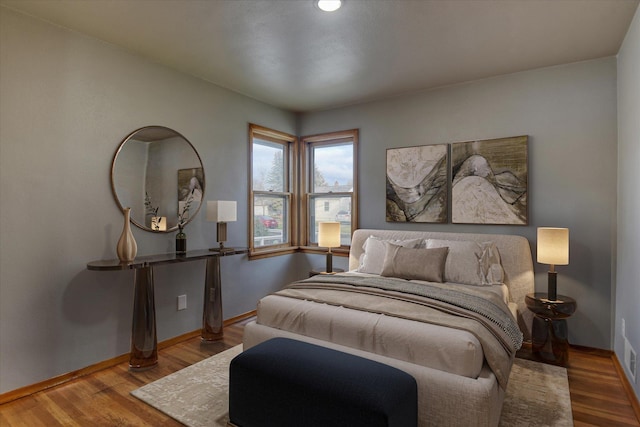 bedroom featuring wood finished floors and baseboards