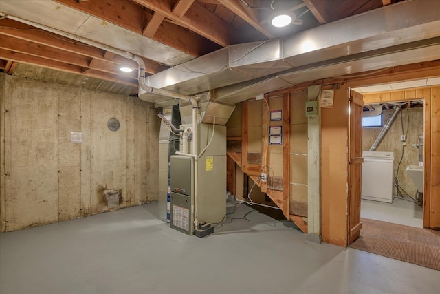 basement featuring a sink and heating unit