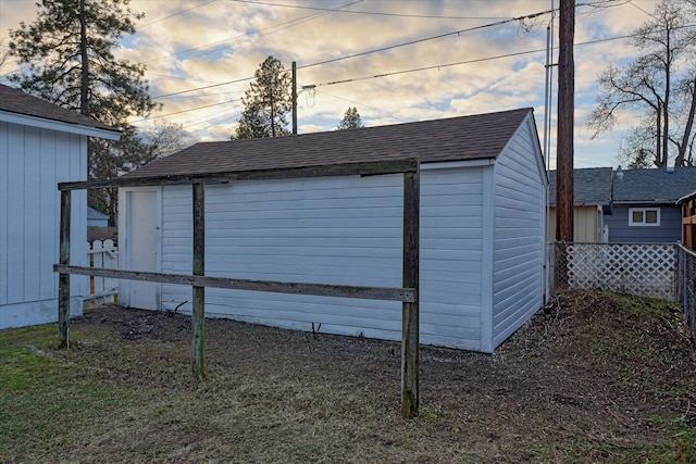 view of outbuilding featuring an outdoor structure and fence