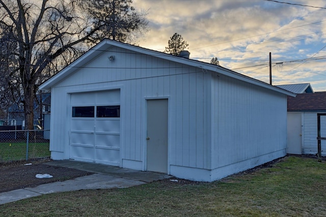 detached garage featuring fence