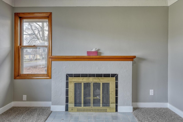 details with baseboards and a glass covered fireplace