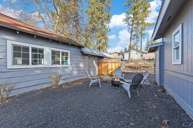 exterior space with a fire pit and fence