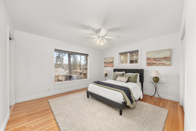 bedroom featuring light wood-type flooring, ceiling fan, and baseboards