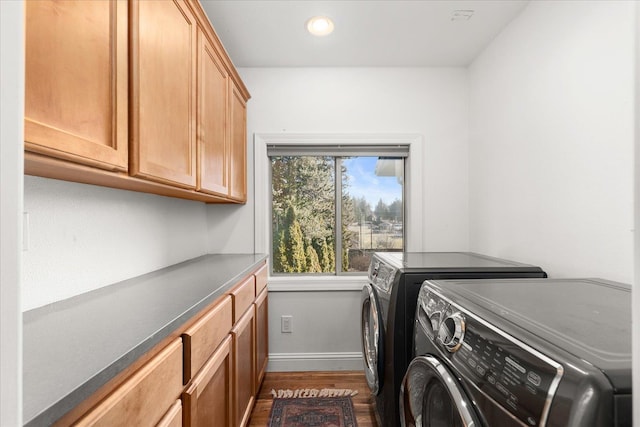 laundry area featuring washer and clothes dryer, recessed lighting, cabinet space, dark wood-type flooring, and baseboards