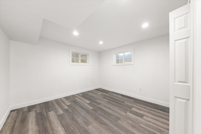 unfurnished room featuring dark wood-type flooring, recessed lighting, and baseboards